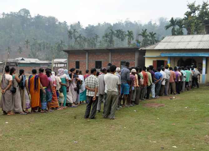 Voters wait in queues to cat their ballots at a polling booth in Harlibagan village, Meghalaya, on Wednesday