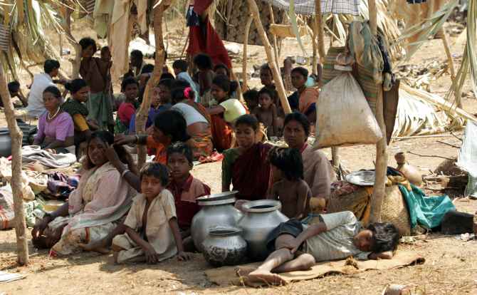 Villagers sit in a refugee camp meant for victims of Maoist violence, in Chhatttisgarh