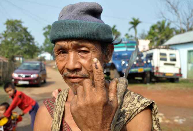 A tribal man shows the indelible mark on his finger after casting his ballot at Harlibagan, 70 kms from Shillong, in Meghalaya on Wednesday
