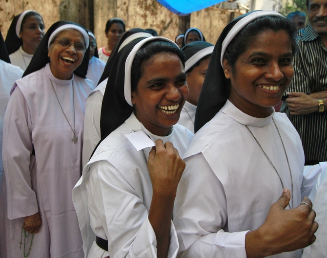 Nuns smile as they wait in a line to cast their votes for the general election outside a polling station in the southern Indian city of Kochi.