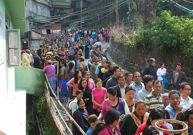 Voters seen in queue waiting for their turn to cast vote at a polling booth in Sikkim