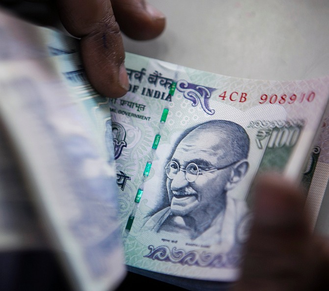 A bank official counts currency notes. Photograph used for representational purposes only.