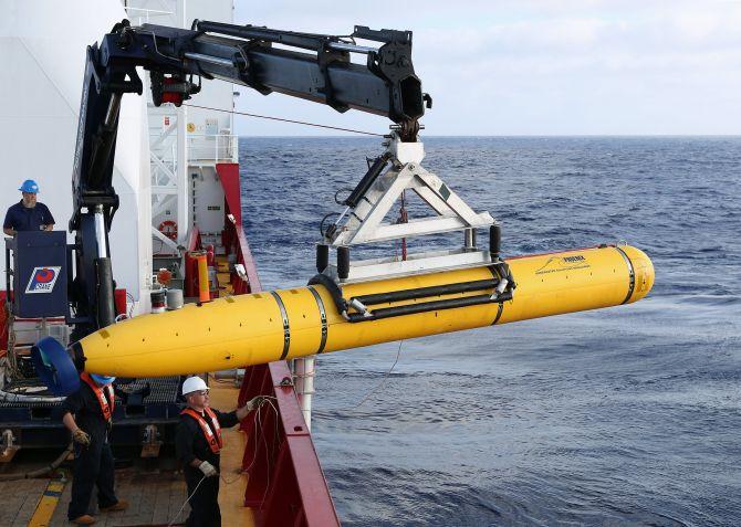 Crew aboard the Australian Defence Vessel Ocean Shield move the US Navy's Bluefin-21 autonomous underwater vehicle into position for deployment in the southern Indian Ocean to look for the missing Malaysia Airlines flight MH370