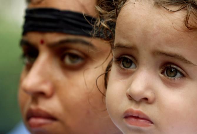 A Kashmiri Pandit lady and her daughter attend a demonstration to protest against militancy in Kashmir, September 14, 2006.