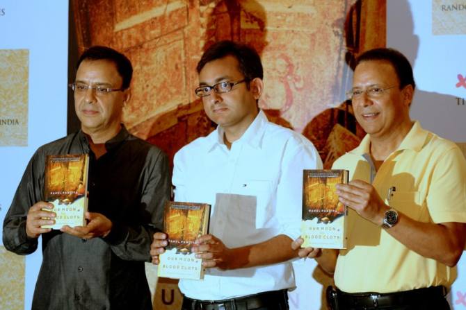 Rahul Pandita, centre, with filmmaker Vidhu Vinod Chopra, left, and his brother Vir Chopra at the launch of Our Moon Has Blood Clots.