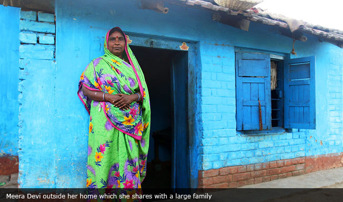 Meera Devi outside her home which she shares with a large family