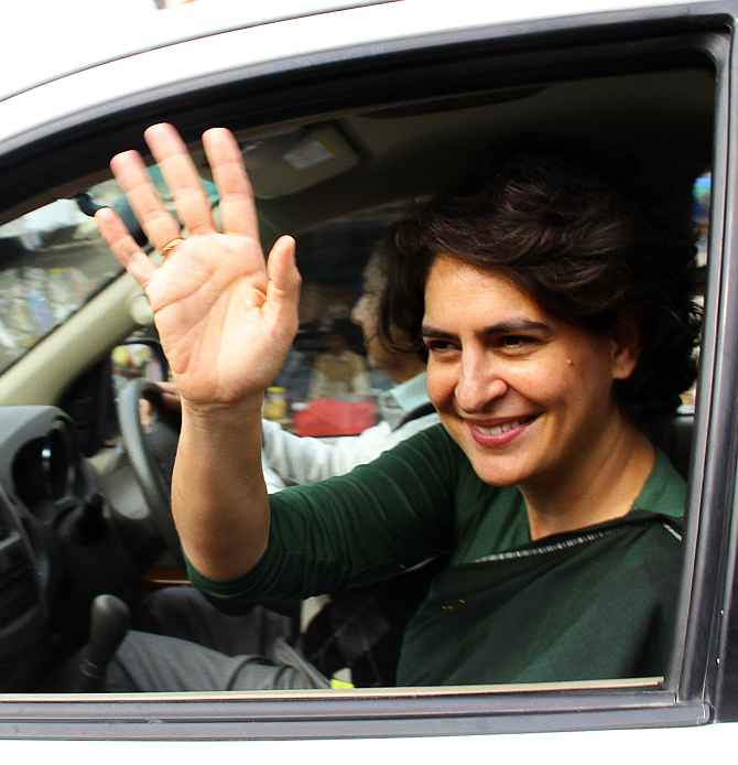 Priyanka Gandhi waves to her supporters after a meeting in Rae Bareli