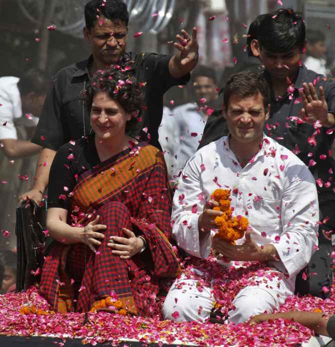 Supporters shower rose petals on Rahul and Priyanka Gandhi before Rahul filed his nomination papers from Amethi