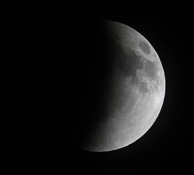 A shadow falls on the moon as it undergoes a total lunar eclipse as seen from Mexico City