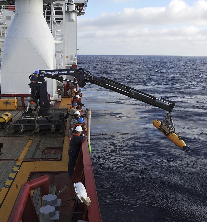 Operators aboard the Australian Defense Vessel Ocean Shield move the US Navy's Bluefin 21 autonomous underwater vehicle into position for deployment in the Southern Indian Ocean, as the search continues for the missing Malaysia Airlines Flight 370