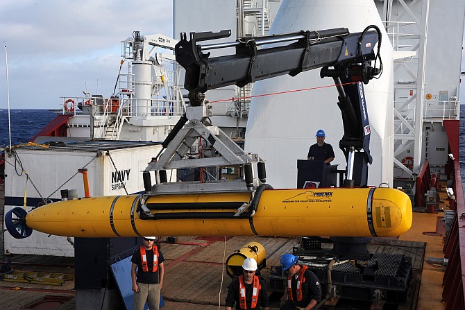 Crew aboard the Australian Defence Vessel Ocean Shield move the US Navy's Bluefin-21 autonomous underwater vehicle into position for deployment in the southern Indian Ocean to look for the missing Malaysia Airlines flight MH370