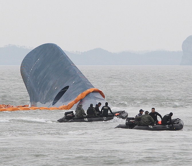 Members of the South Korean Navy search for missing passengers at the site of the sunken ferry off the coast of Jindo Island