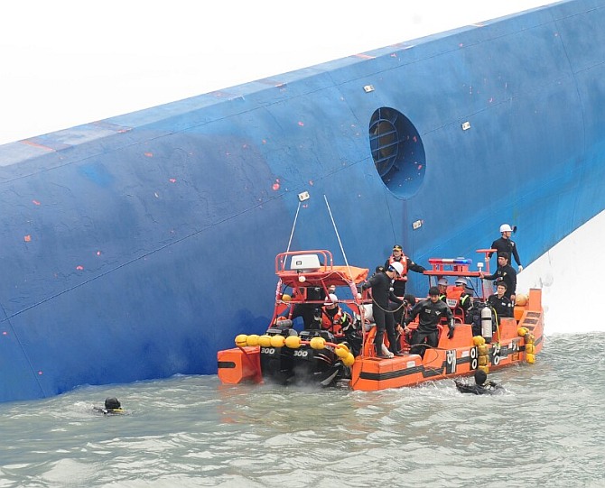 In this handout image provided by the Republic of Korea Coast Guard, the rescue work by members of the Republic of Korea Coast Guard continues around the site of ferry sinking accident off the coast of Jindo Island