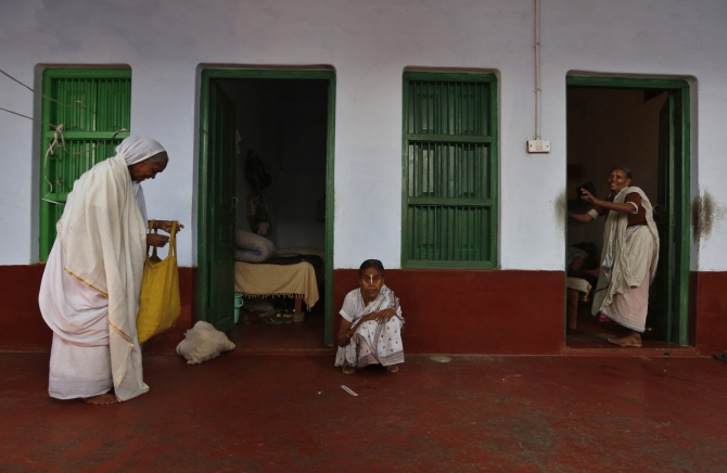 Widows stand outside their rooms at the Meera Sahavagini ashram in Vrindavan, Uttar Pradesh.