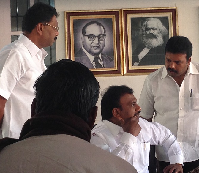 A Raja interacts with DMK workers at his party office in Ooty. The portraits of Dr B R Ambedkar and Karl Marx can be seen in the background.