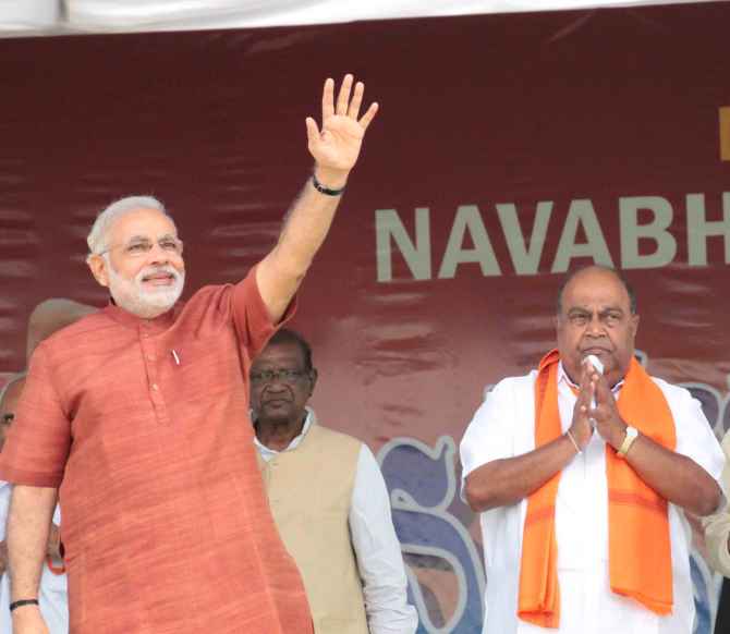 Narendra Modi greets supporters at a rally in Hyderabad.