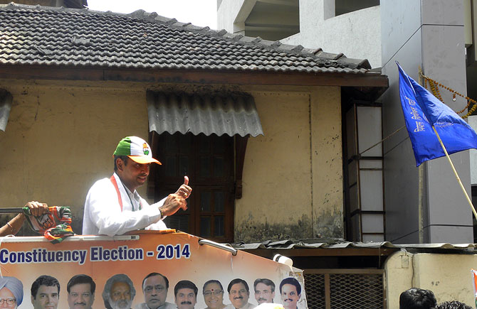 Candidate Deora flashes the thumbs up sign in Byculla.