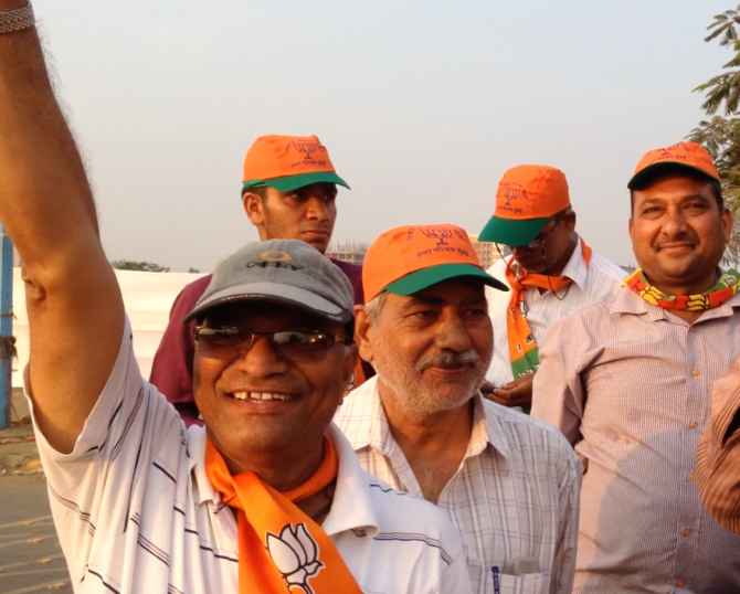 Supporters of Narendra Modi cheer for their leader ahead of his rally on Monday