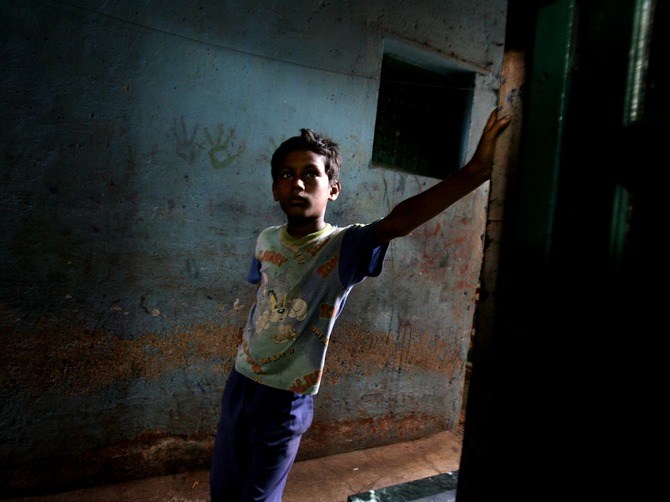 In search of hope: A young boy looks on in an alley at the Dharavi slums in Mumbai.