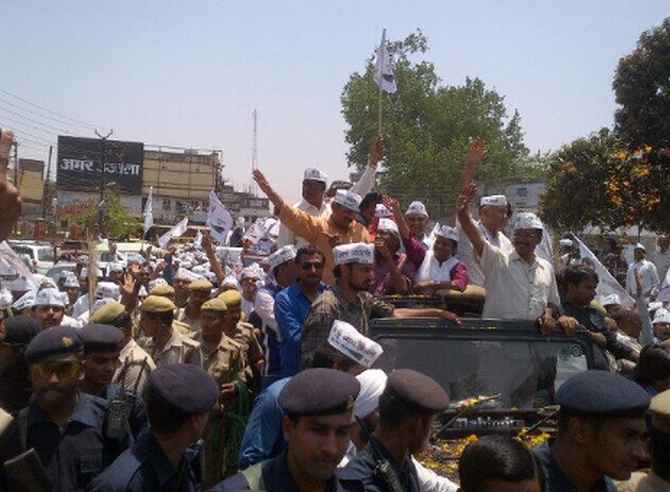Kejriwal greets supporters during a road show in Varanasi on Wednesday