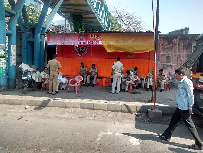 Constables and officers belonging to Mumbai Police, State Reserve Police Force and Central Paramilitary Force take rest under the Bandra East footover bridge in an area sponsored by the local unit of the Shiv Sena