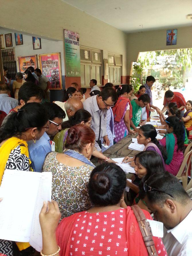 Voters check for their names on voter lists in Mumbai