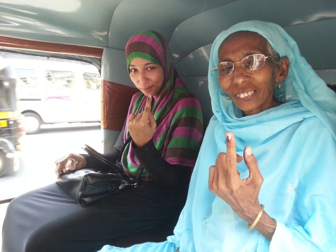 Tazeen and her mother leave the polling station after casting their vote.