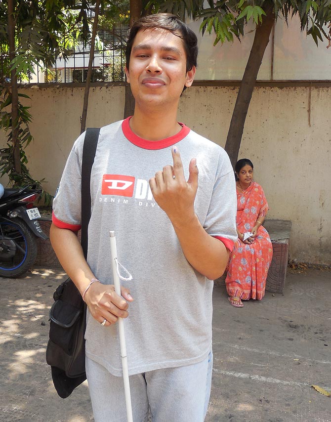 A visually impaired Divesh Sharma outside the poll station after voting