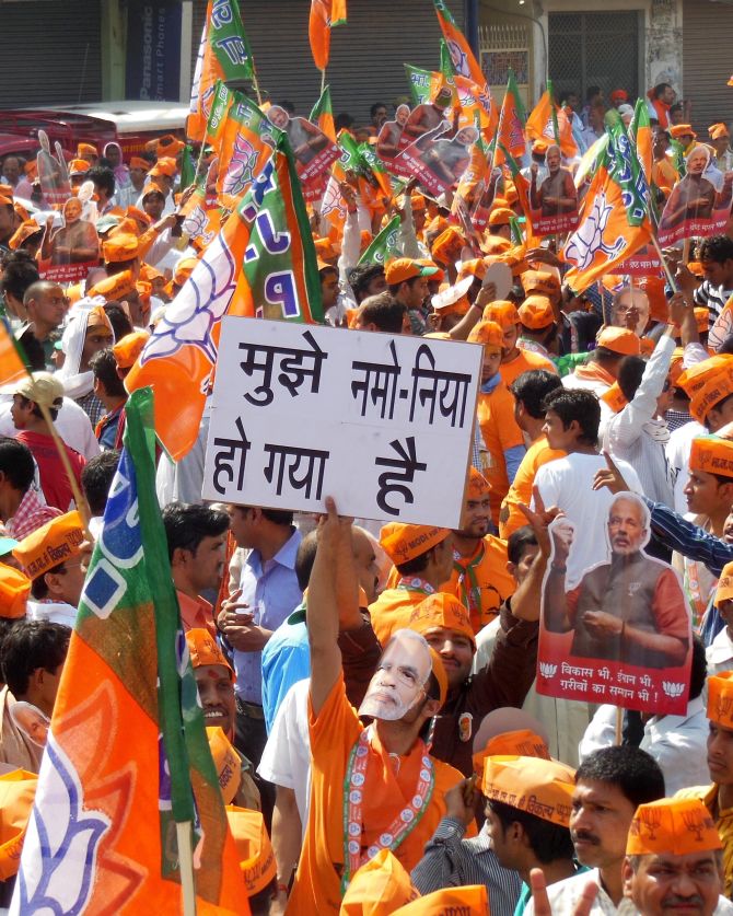 Supporters of BJP prime ministerial candidate Narendra Modi cheer for their leader in Varanasi