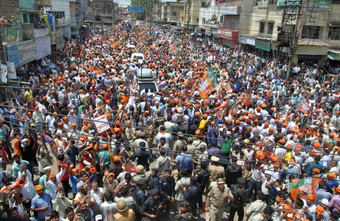 Narendra Modi's procession snakes through Varanasi as supporters try to catch a glimpse of their leader