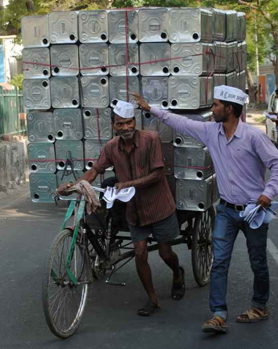 An AAP volunteer places a party cap on a member of the public in Lucknow.