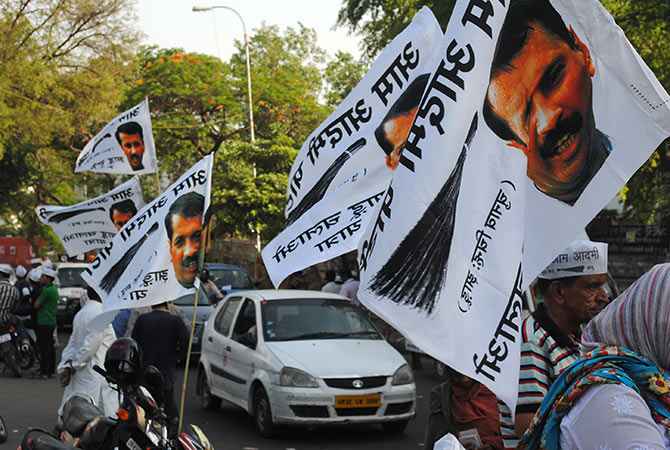 Posters and flags showing AAP chief Arvind Kejriwal at a road show in Lucknow.