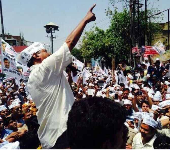 AAP leader Arvind Kejriwal addresses a road show in Varanasi.