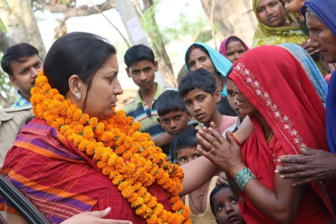 Smriti Irani speaks to a resident of Shukla Bazar during her campaign trail.