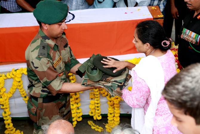 The major's wife Indhu Rebecca Varghese, receives his uniform.