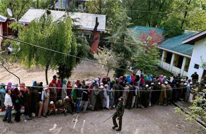 People wait to cast their vote for Srinagar Lok Sabha constituency at a polling station in Ganderbal district on  Wednesday.