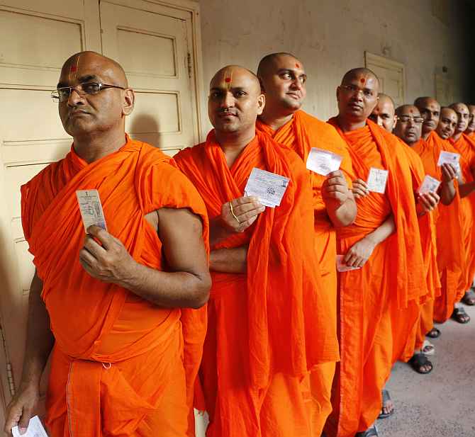 Monks of Swaminarayan temple queue up to cast their votes at a polling booth in Ahmedabad on Wednesday