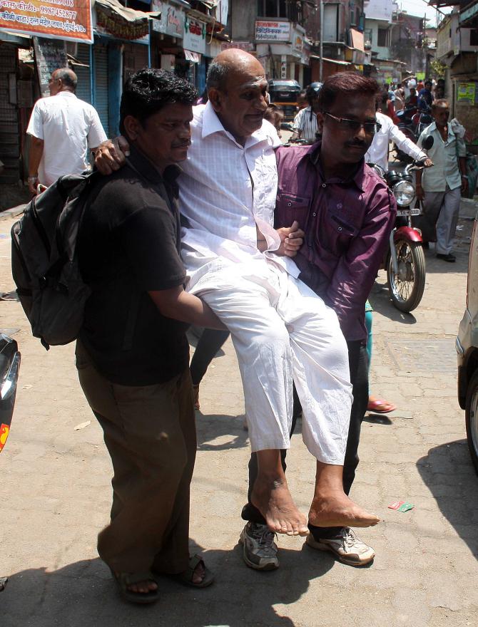 A elderly person gets out to vote in Mumbai