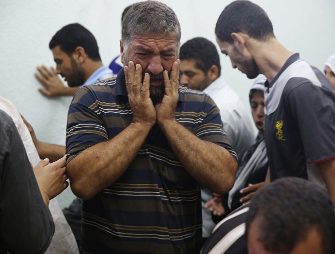 A Palestinian man mourns a relative who medics said died in Israeli shelling during an Israeli ground offensive, at the hospital morgue in Beit Lahita in the northern Gaza Strip.