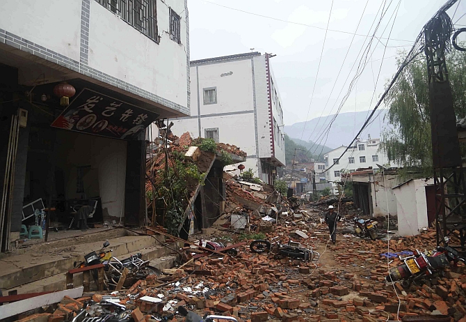 Debris of collapsed houses are seen scattered along a street, after a deadly earthquake hit Longtoushan town