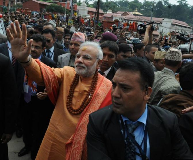 PM Narendra Modi waves to the thousands who thronged the roads of Nepal during his two-day visit