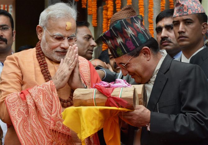 Prime Minister Narendra Modi gifts sandalwood to the Pashupatinath temple after praying at the temple.