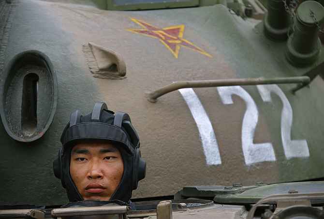 A Chinese soldier stands inside a tank during a military exercise in Beijing.