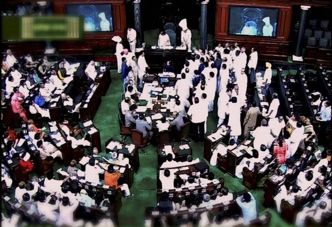Congress members storm the Well in the Lok Sabha demanding a discussion on communal tension in the country