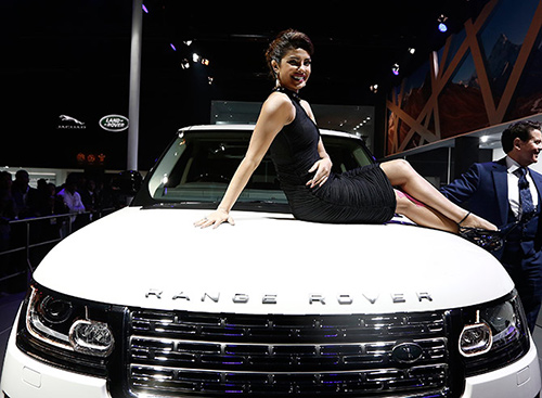Actress Priyanka Chopra poses with Jaguar Land Rover's Range Rover LWB during its launch at the Indian Auto Expo in Greater Noida.