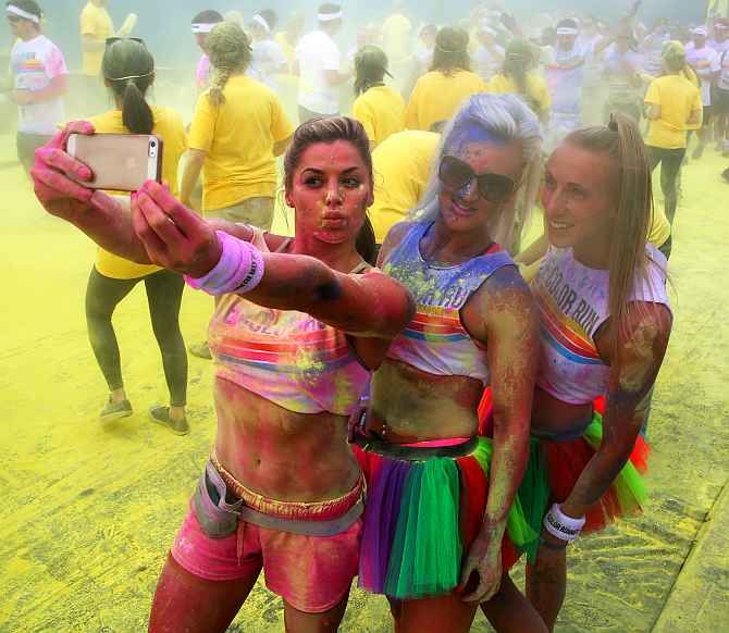 Participants pose for a selfie as they take part in the Colour Run in London.