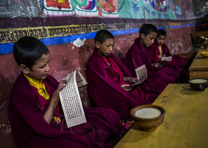Young Buddhist monks pray during morning prayers at the Thikse Monastery near Leh