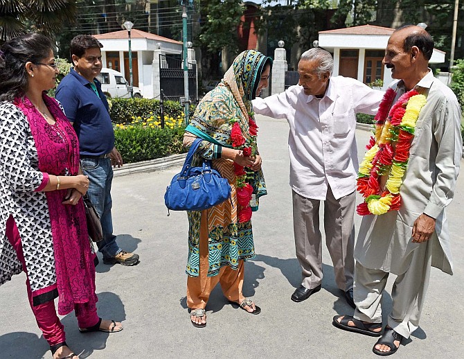 Celebrating the spirit of friendship: Tandons from Jammu receiving Mughals from PoK (with garlands) in Srinagar on Wednesday.