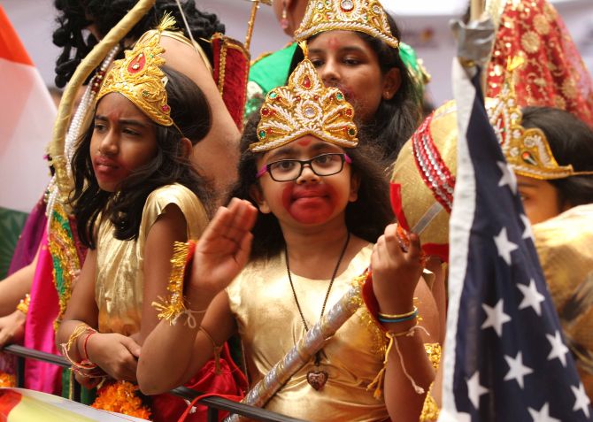 Some children on a flotilla dress up like Hindu gods Ram and Hanuman during the parade. 