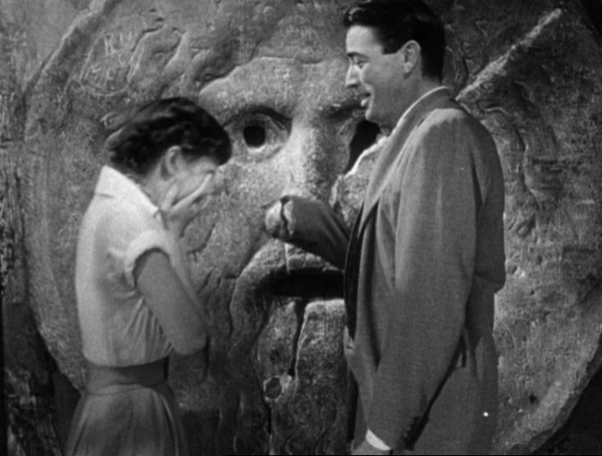 A scene from the 1953 movie Roman Holiday featuring Audrey Hepburn, Gregory Peck at the Mouth of Truth.